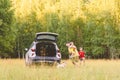 During picnic at nature family playing tag game around car Royalty Free Stock Photo