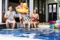 Family playing musical instruments by the pool Royalty Free Stock Photo