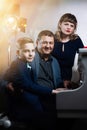 Family playing on the piano. Father and mother teaches son to play a musical instrument Royalty Free Stock Photo