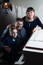 Family playing on the piano. Father and mother teaches son to play a musical instrument Royalty Free Stock Photo