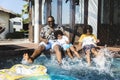 Family playing by a pool Royalty Free Stock Photo