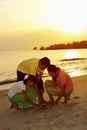 Family playing with sand on the beach. Conceptual image Royalty Free Stock Photo