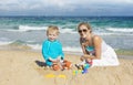 Family playing in the sand at the beach Royalty Free Stock Photo