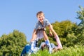 Family playing with son lying in grass on meadow Royalty Free Stock Photo