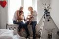 Family playing and spending time near window. Sunny day outside Royalty Free Stock Photo