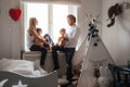 Family playing and spending time near window. Sunny day outside Royalty Free Stock Photo