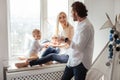 Family playing and spending time near window. Sunny day outside Royalty Free Stock Photo