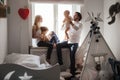 Family playing and spending time near window. Sunny day outside Royalty Free Stock Photo