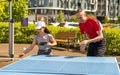 Family playing table tennis outside house Royalty Free Stock Photo