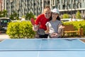 Family playing table tennis outside house Royalty Free Stock Photo