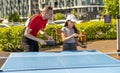 Family playing table tennis outside house Royalty Free Stock Photo