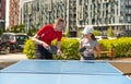 Family playing table tennis outside house Royalty Free Stock Photo