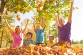 Family playing and throwing leaves in the air Royalty Free Stock Photo