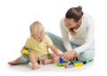 Family playing together. Mom and son play building block toys. Mother and child sitting on the floor. Isolated on white Royalty Free Stock Photo