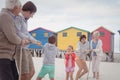 Family playing tug of war at beach Royalty Free Stock Photo