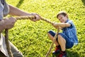 Family playing tug of war at the park Royalty Free Stock Photo