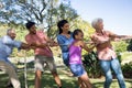 Family playing tug of war in the park Royalty Free Stock Photo