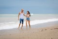 Family playing on wet sand in time of surf Royalty Free Stock Photo