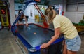 Family plays air hockey