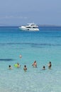 Family plays with the ball taking a bath in the sea