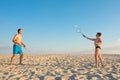 The family plays beach badminton. Sports, lifestyle. Family games in summer on vacation