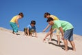 Family plays on the beach, found something