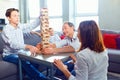 The family plays board games gaily while sitting at the table. Royalty Free Stock Photo