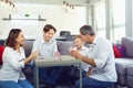 The family plays board games inside the room. Royalty Free Stock Photo