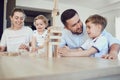 A family plays board games sitting at a table indoors. Royalty Free Stock Photo