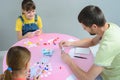 Family plays board games at the table, top view