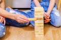 Family plays wooden tower game of wood sticks Royalty Free Stock Photo