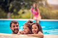 Portrait of father and kids in the pool Royalty Free Stock Photo