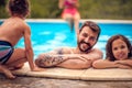 Portrait of father and kids in the pool Royalty Free Stock Photo