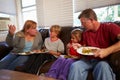 Family With Poor Diet Sit On Sofa Eating Meal And Arguing Royalty Free Stock Photo