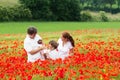 Family in poppy flower meadow Royalty Free Stock Photo