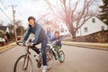 Family portrait on bicycles, son towed in tandem