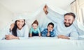 Family, portrait and blanket fort in bed with children and parents, happy and playing in their home. Face, under and Royalty Free Stock Photo