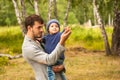 Family portrait. Father play with his child. Father holding a child in his arms. They are happy. Happy family walking outdoor Royalty Free Stock Photo