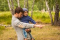 Family portrait. Father play with his child. Father holding a child in his arms. They are happy. Happy family walking outdoor Royalty Free Stock Photo