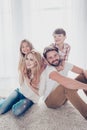 Family portrait of four. Happy parents are piggy backing thier Royalty Free Stock Photo