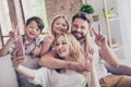 Family portrait of four, showing peace signs. Happy parents and Royalty Free Stock Photo