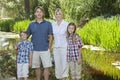 Family portrait of four standing against lake Royalty Free Stock Photo