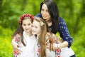 Family portrait of girls and mother in the park on a background