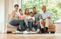 Family in portrait, grandparents and parents with children relax on sofa with smile, generations and bonding at home