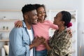 Happy african american family greeting mother soldier Royalty Free Stock Photo