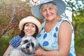 Family portrait of a happy elderly woman hugging her daughter and their dog Royalty Free Stock Photo