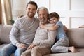 Family portrait happy grandfather, father and little boy at home