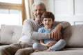 Family portrait happy mature grandfather hugging adorable little grandson