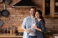 Family portrait happy young couple drinking coffee in kitchen Royalty Free Stock Photo