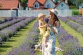 Family portrait in lavender field, mother and daughter together having fun